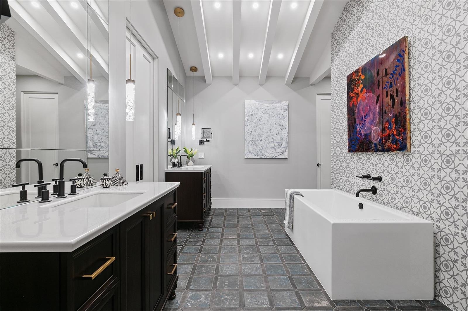 primary bathroom with black cabinets and white modern fixtures